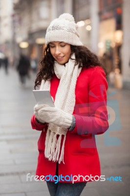 Woman In Red Coat And Wool Cap And Gloves With Smartphone In Han… Stock Photo