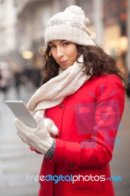 Woman In Red Coat And Wool Cap And Gloves With Smartphone In Han… Stock Photo