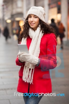 Woman In Red Coat And Wool Cap And Gloves With Smartphone In Han… Stock Photo