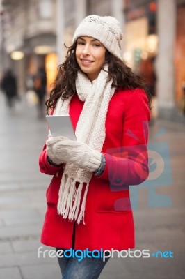 Woman In Red Coat And Wool Cap And Gloves With Smartphone In Han… Stock Photo