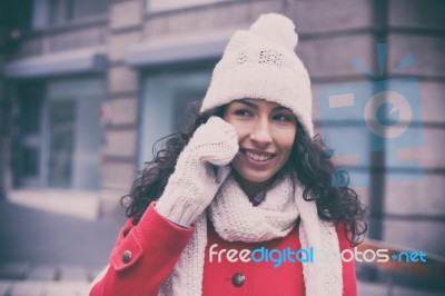 Woman In Red Coat And Wool Cap And Gloves With Smartphone In Han… Stock Photo