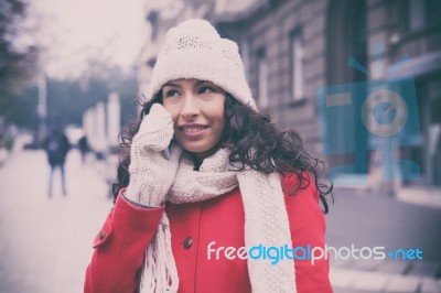 Woman In Red Coat And Wool Cap And Gloves With Smartphone In Han… Stock Photo