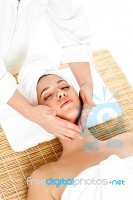 Woman In Spa Gets A Facial Massage Stock Photo