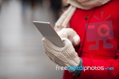 Woman In Wool Gloves Hold Smart-phone Stock Photo