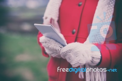 Woman In Wool Gloves Hold Smart-phone Stock Photo