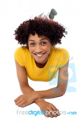 Woman In Yellow Top Relaxing On Studio Floor Stock Photo