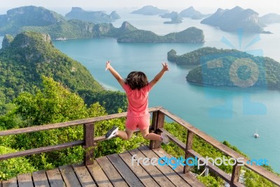 Woman Jumping On Mountain Stock Photo