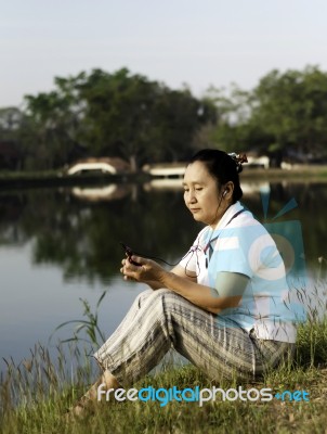 Woman Listening To Mp3 Stock Photo