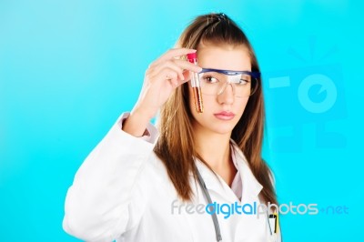 Woman Looking At The Chemical Tube Stock Photo