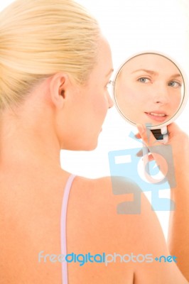 Woman Looking In Mirror Stock Photo