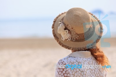 Woman Looking Into The Sea Stock Photo