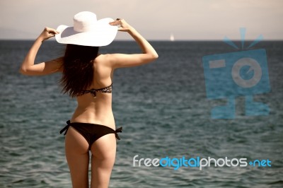 Woman Looking Out At Ocean Stock Photo