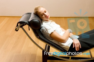 Woman Lying On Chaise Longue Stock Photo