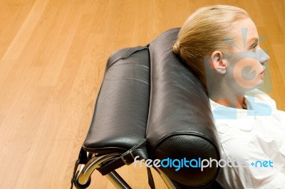 Woman Lying On Chaise Longue Stock Photo