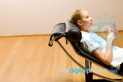 Woman Lying On Chaise Longue Stock Photo