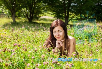 Woman Lying On The Grass In The Park Stock Photo