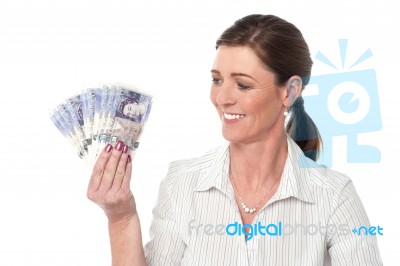 Woman Making Fan Of Pound Sterling Banknotes Stock Photo