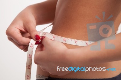 Woman Measuring Her Slim Waist With A Tape Stock Photo