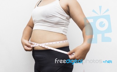 Woman Measuring Her Waistline Fat Tummy On Gray Background Stock Photo