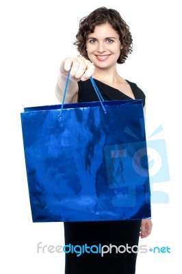 Woman Offering You Bright Blue Shopping Bag Stock Photo