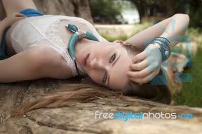 Woman On The Beach Lying On Branch Stock Photo