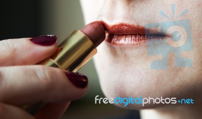 Woman Paints Lips With Lipstick Stock Photo