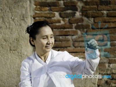 Woman Playing A Bell, Traditionally Used To Aid Meditation In Bu… Stock Photo