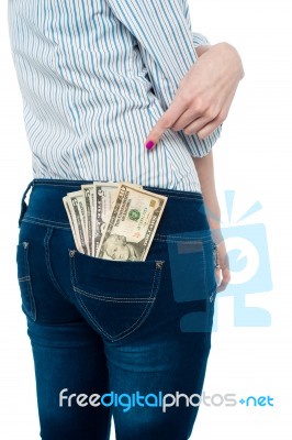 Woman Pointing At Dollar Notes In Her Back Pocket Stock Photo