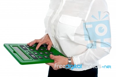 Woman Pressing Digit 6 On Calculator Stock Photo