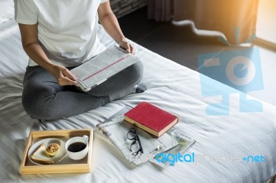 Woman Reading Book Or Newspaper And Drinking Coffee Breakfast On… Stock Photo