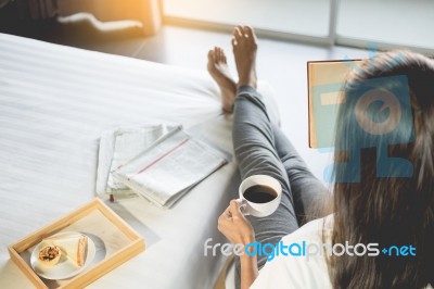 Woman Reading Book Or Newspaper And Drinking Coffee Breakfast On… Stock Photo