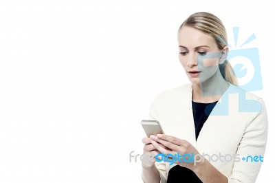 Woman Reading Message On Her Phone Stock Photo