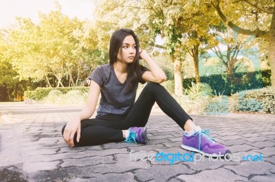 Woman Relaxing After Sports. Hipster Student In The City Park Stock Photo