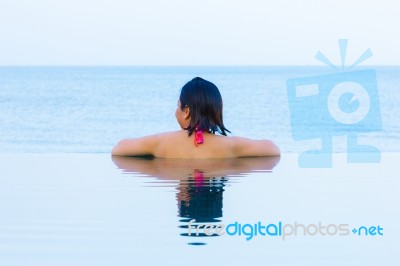 Woman Relaxing Infinity Swimming Pool Stock Photo