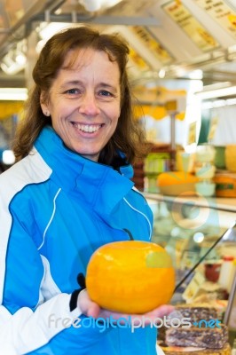 Woman Showing Round Cheese Stock Photo