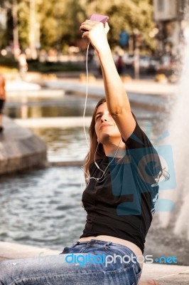 Woman Sitting  And Making Selfie Stock Photo