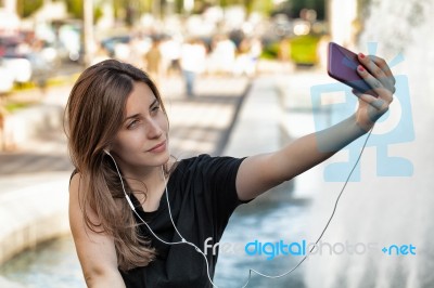 Woman Sitting  And Making Selfie Stock Photo