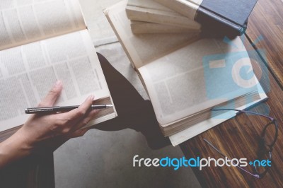 Woman Sitting In A Cafe, Reading Book Stock Photo