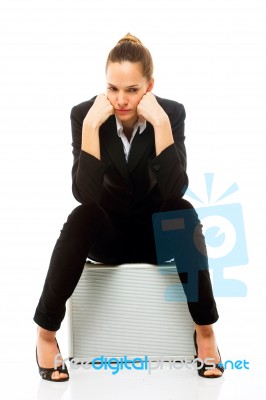 Woman Sitting On Briefcase Stock Photo