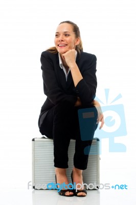 Woman Sitting On Briefcase Stock Photo