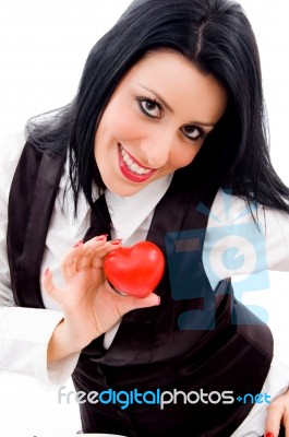 Woman Smiling And Holding A Small Red Heart Stock Photo