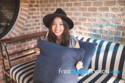 Woman Smiling Near Rustic Brick Wall Stock Photo