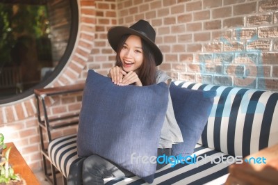 Woman Smiling Near Rustic Brick Wall Stock Photo