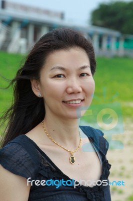 Woman Smiling On A Tropical Beach Stock Photo