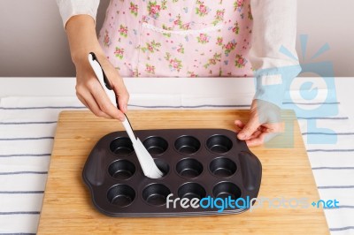 Woman Spread Oil In Baking Pan Stock Photo