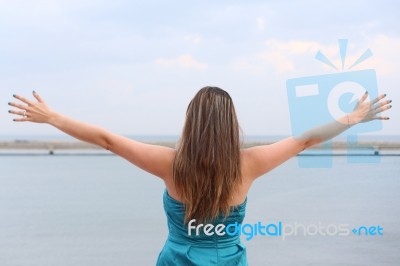 Woman Standing Back With Open Arms Stock Photo