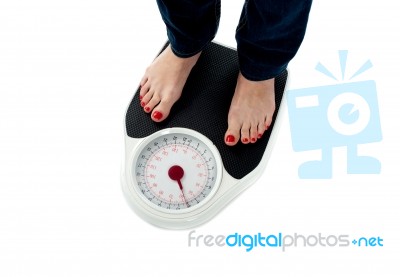 https://www.freedigitalphotos.net/images/previews/woman-standing-on-weighing-scale-100101223.jpg