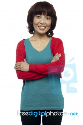 Woman Standing With Arms Crossed Stock Photo