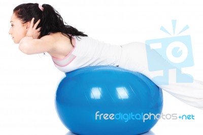 Woman Stretching On The Blue Ball Stock Photo