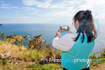 Woman Taking Photograph With Smartphone Stock Photo